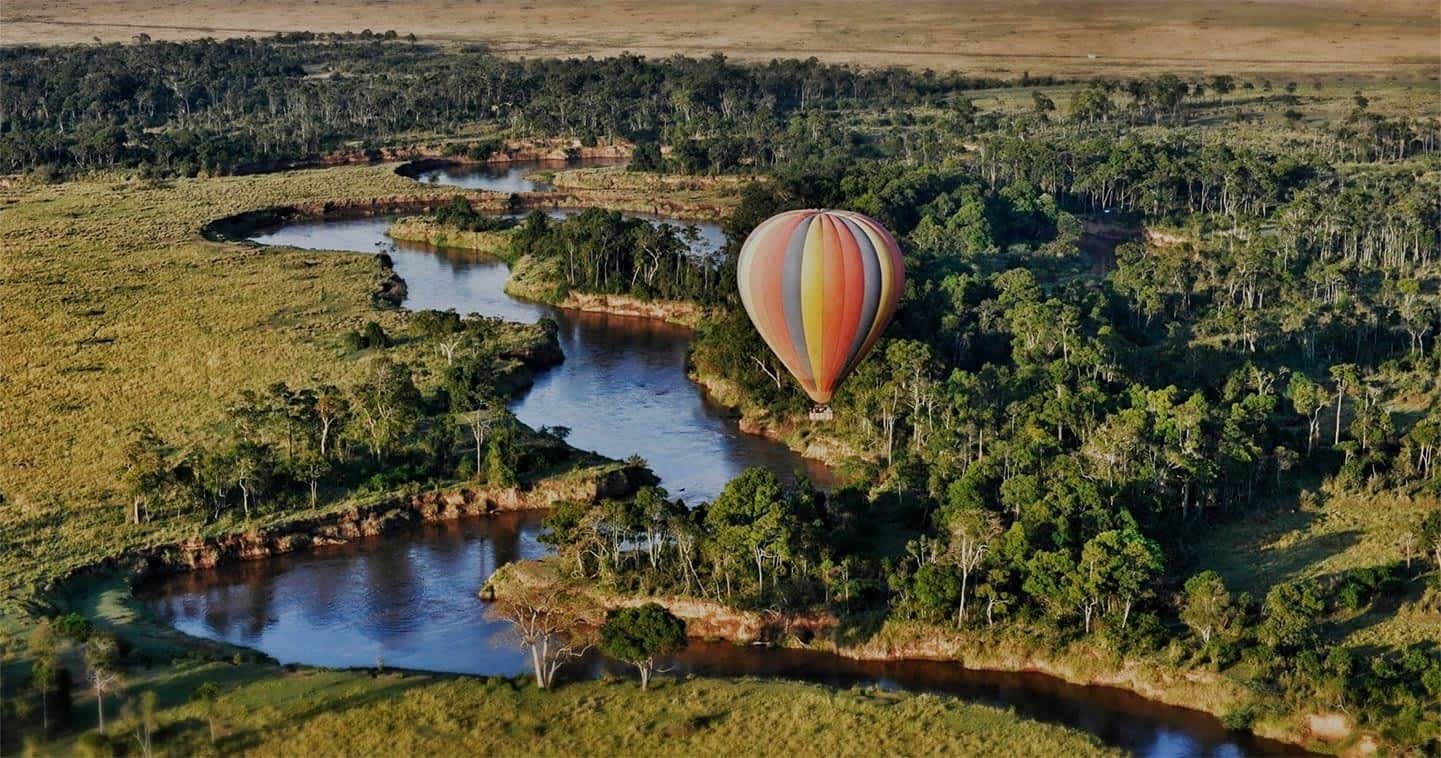 Hot air balloon floating above the vast plains of Serengeti National Park